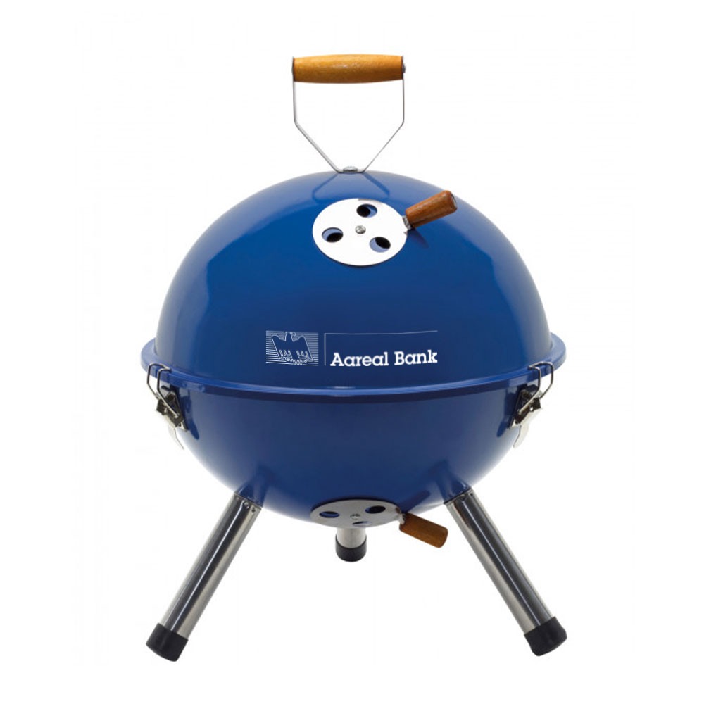Ein kleiner, runder, blauer Holzkohlegrill mit Metallbeinen und Holzgriffen, auf der Vorderseite mit dem Branding „Vollblut Aareal Bank“ versehen, abgebildet vor einem weißen Hintergrund.
